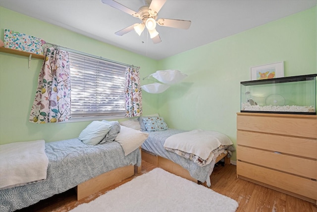 bedroom with hardwood / wood-style floors and ceiling fan