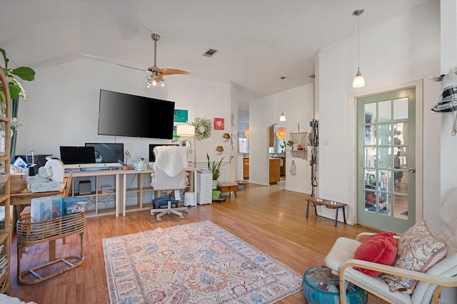 home office featuring light wood-type flooring, vaulted ceiling, and ceiling fan