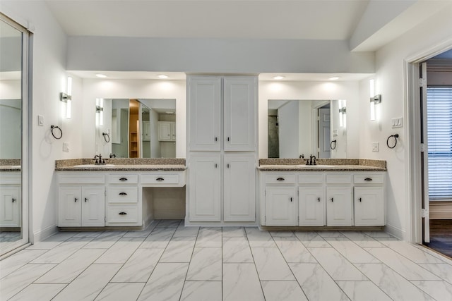 bathroom with vanity and vaulted ceiling