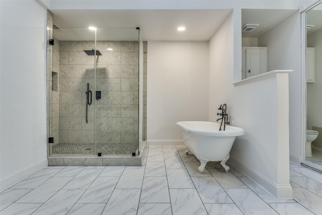 bathroom featuring shower with separate bathtub and toilet