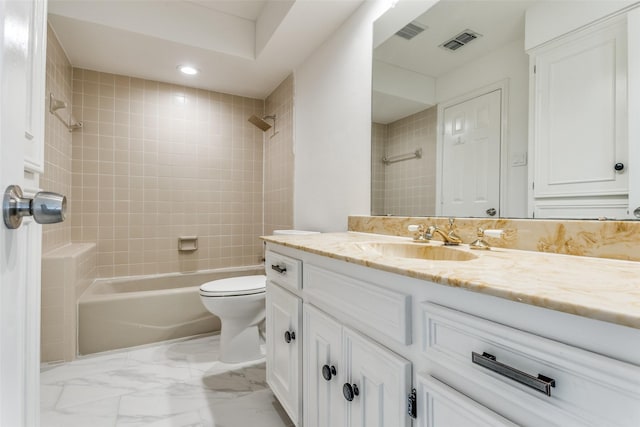 full bathroom with vanity, toilet, and tiled shower / bath combo