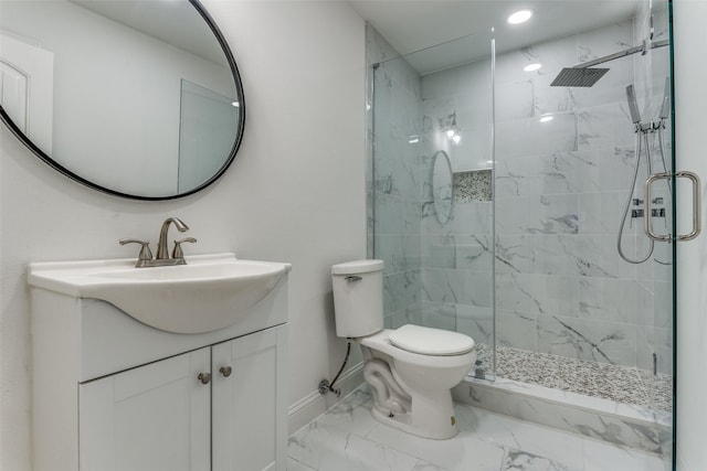 bathroom with vanity, toilet, and a shower with door