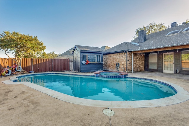 view of swimming pool with an in ground hot tub and a patio area