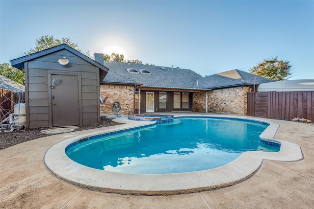 view of swimming pool featuring an in ground hot tub