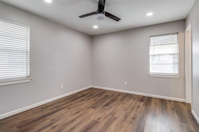 empty room with ceiling fan and dark hardwood / wood-style flooring