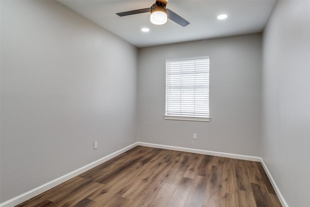 unfurnished room featuring ceiling fan and dark hardwood / wood-style flooring