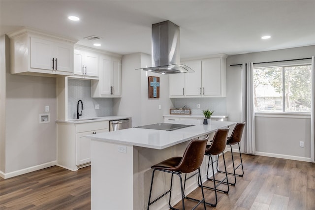 kitchen featuring white cabinetry, island range hood, dishwasher, and wood-type flooring