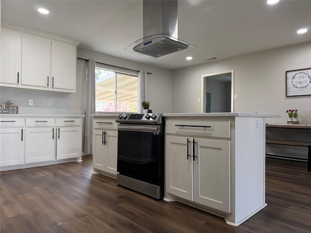 kitchen with tasteful backsplash, dark hardwood / wood-style flooring, island exhaust hood, stainless steel electric range, and white cabinets