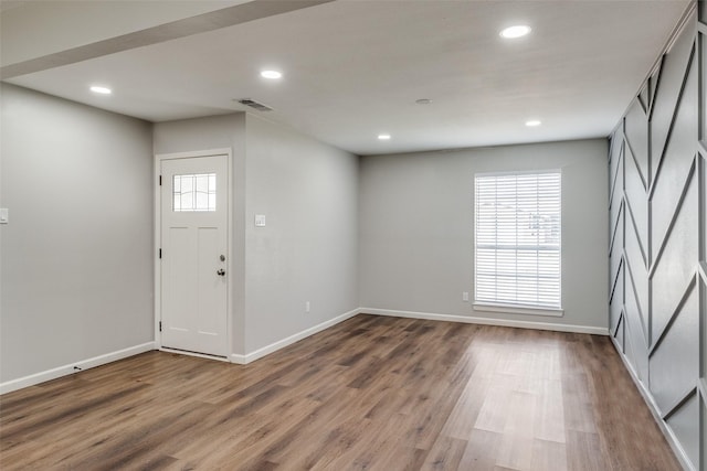 foyer entrance with hardwood / wood-style floors and plenty of natural light