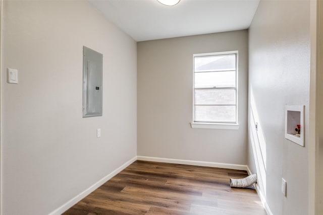 empty room featuring dark hardwood / wood-style flooring and electric panel