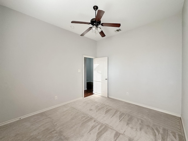 unfurnished room with visible vents, ceiling fan, carpet flooring, and baseboards