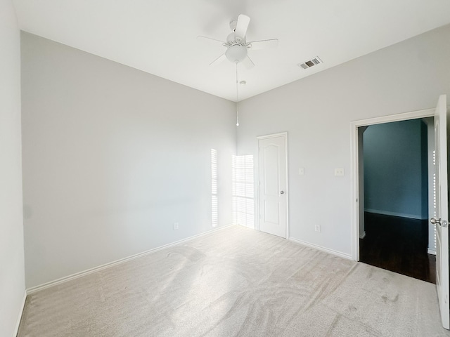 interior space featuring visible vents, baseboards, carpet flooring, and ceiling fan