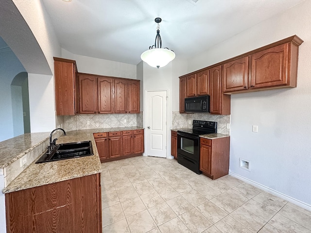 kitchen featuring light stone countertops, sink, pendant lighting, light tile patterned floors, and black appliances