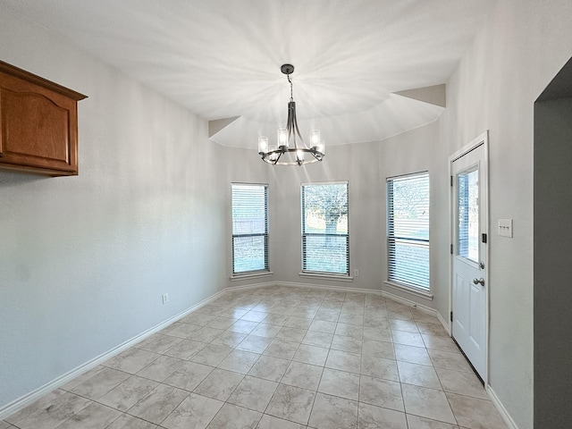 unfurnished dining area with light tile patterned floors, a chandelier, and vaulted ceiling