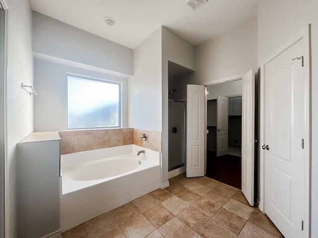 bathroom featuring independent shower and bath