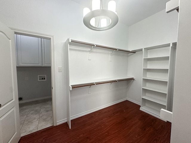 walk in closet with dark hardwood / wood-style flooring