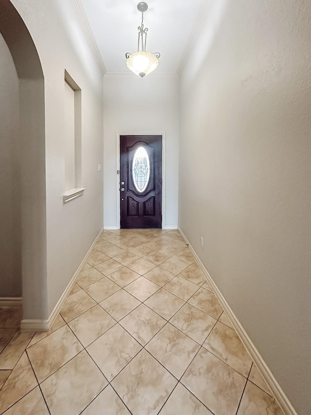 tiled entrance foyer featuring ornamental molding