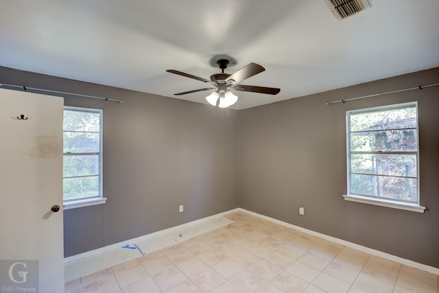 spare room featuring light tile patterned flooring and ceiling fan