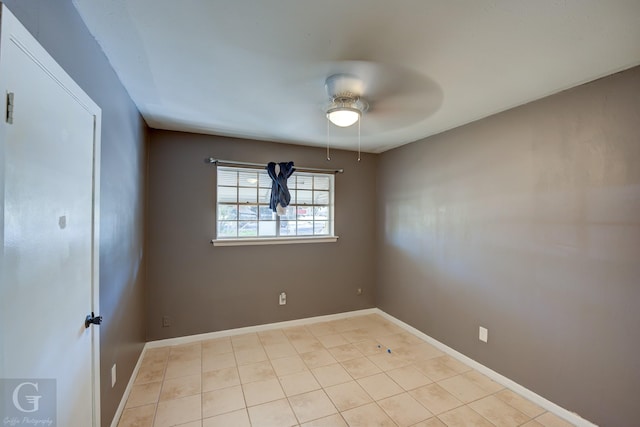 tiled empty room featuring ceiling fan