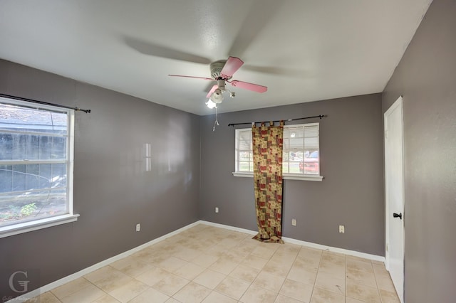 empty room featuring ceiling fan and a healthy amount of sunlight