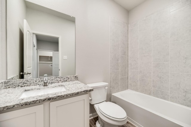 full bathroom with vanity, tiled shower / bath combo, wood-type flooring, and toilet