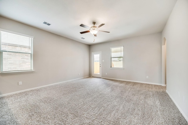 spare room featuring carpet flooring and ceiling fan