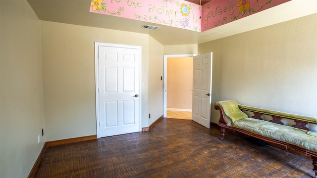 sitting room with dark wood-type flooring