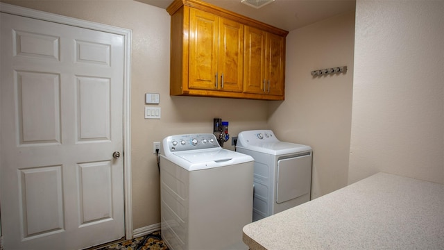 laundry area featuring cabinets and washing machine and dryer