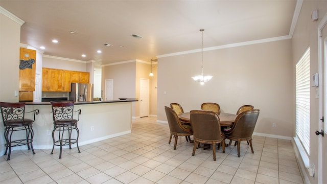 dining area with crown molding, light tile patterned flooring, and an inviting chandelier