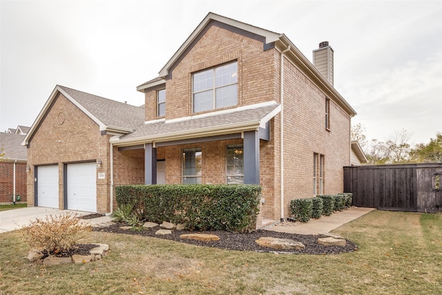 view of property featuring covered porch, a front lawn, and a garage