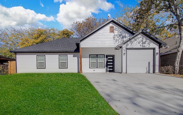 ranch-style house featuring a front lawn and a garage