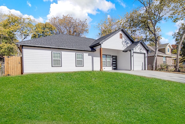 view of front of house featuring a garage and a front lawn