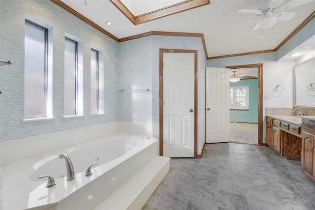 bathroom featuring a jetted tub, ceiling fan, crown molding, and vanity