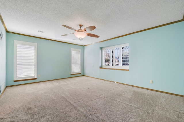 unfurnished room featuring crown molding, light carpet, ceiling fan, and a textured ceiling