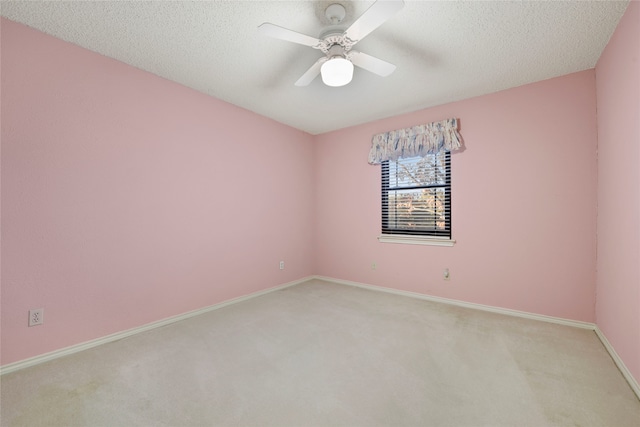 carpeted spare room with ceiling fan and a textured ceiling