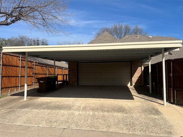 view of parking / parking lot with fence and a carport