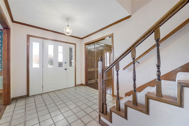 entryway with crown molding, light tile patterned floors, a textured ceiling, baseboards, and stairs