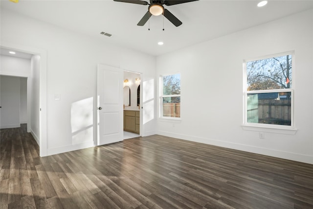 unfurnished bedroom featuring ceiling fan, dark hardwood / wood-style floors, and ensuite bath