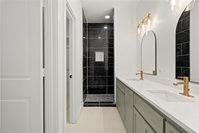 bathroom featuring a tile shower, vanity, and tile patterned floors