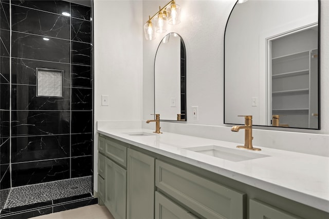 bathroom with vanity and a tile shower