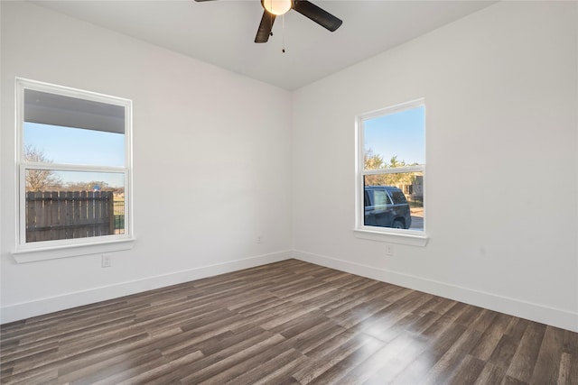 spare room with dark wood-type flooring and ceiling fan