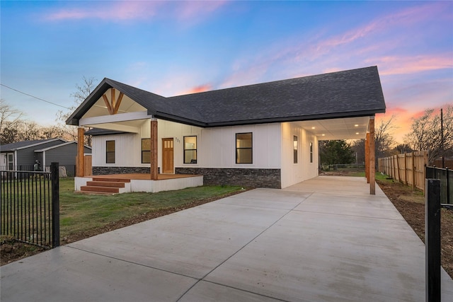 view of front of home featuring a carport and a yard