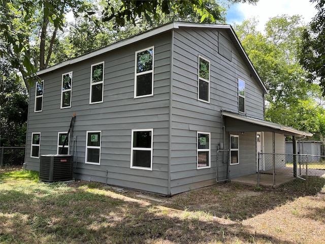 rear view of house with central AC