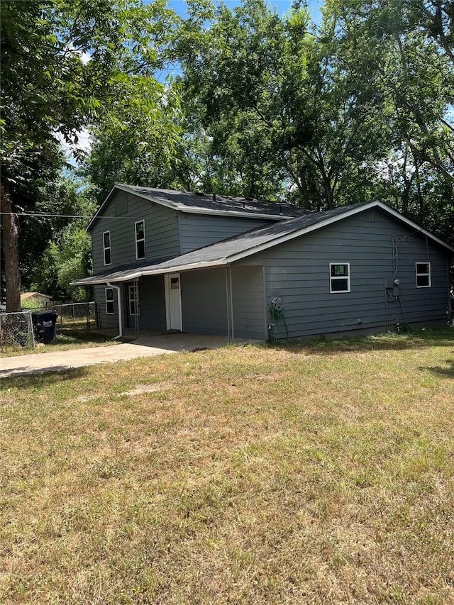 view of side of home with a yard