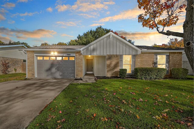 ranch-style house with a lawn and a garage