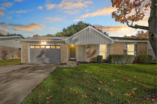 ranch-style house with a lawn and a garage