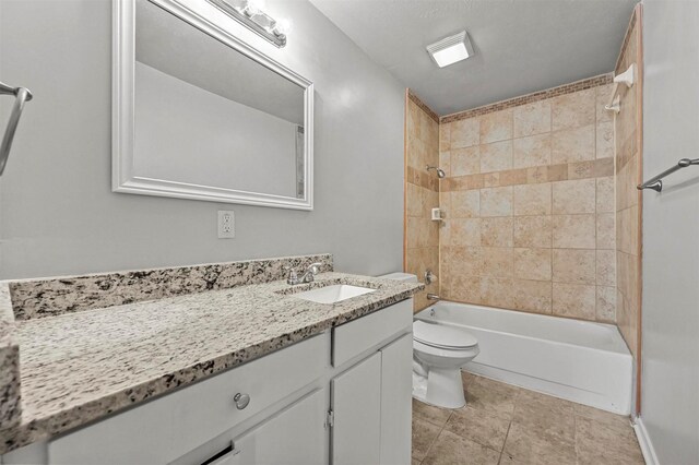 full bathroom with tile patterned floors, toilet, vanity, and tiled shower / bath