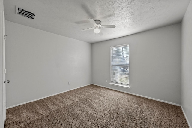 carpeted empty room featuring ceiling fan and a textured ceiling