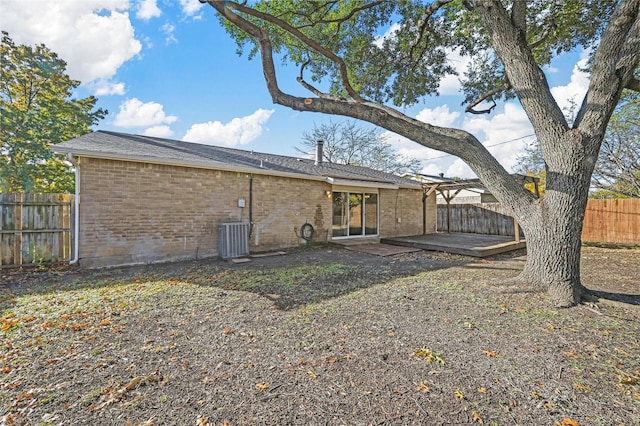 rear view of house featuring central AC unit and a patio area