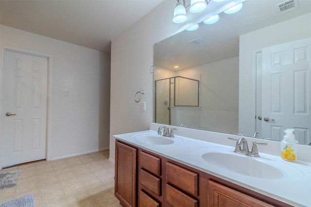 bathroom featuring a shower with door and vanity